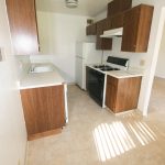 Cascade Apartments kitchen area with dark cabinets and white counters